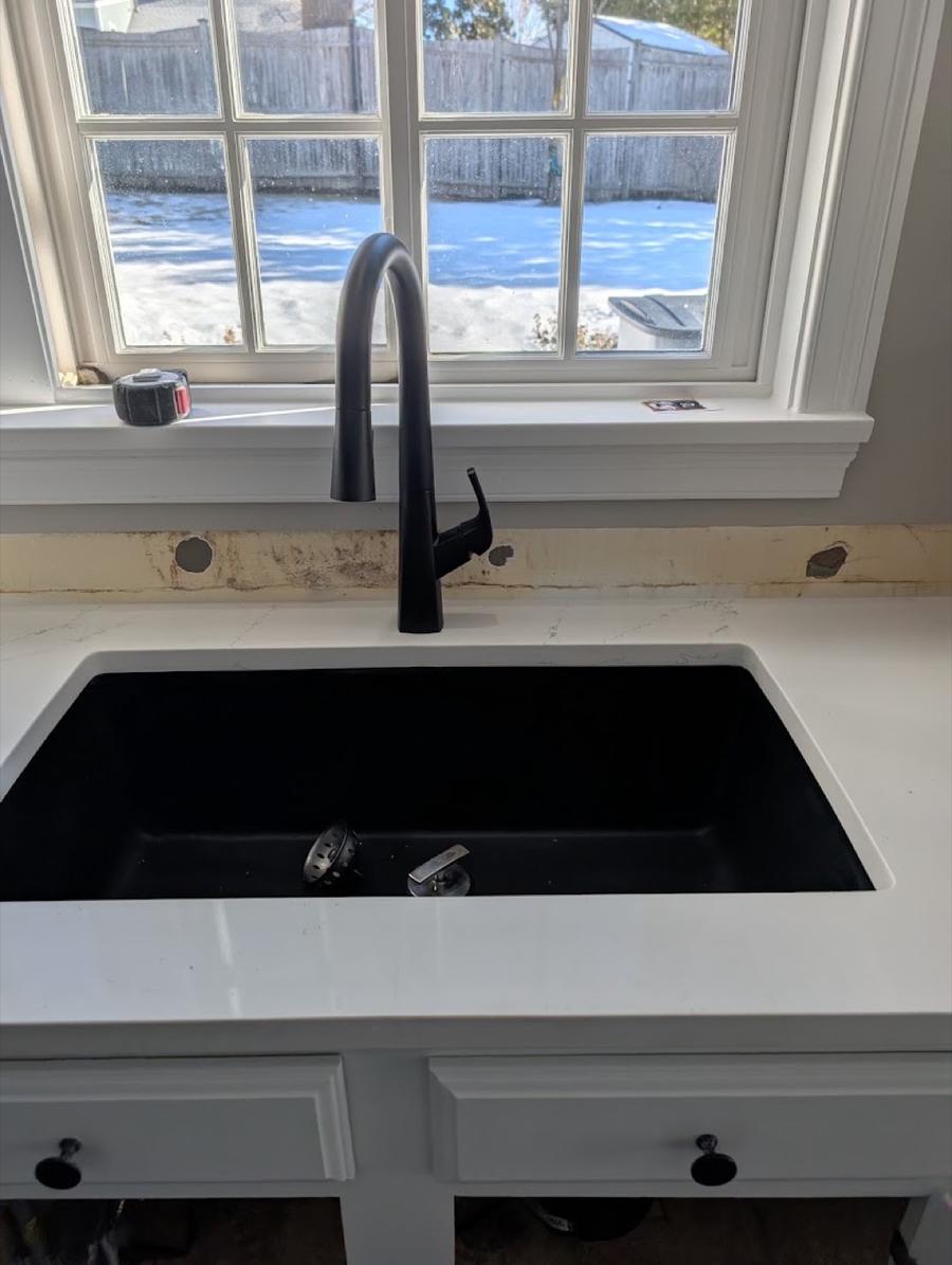 Kitchen sink with a new matte-black pull-down faucet